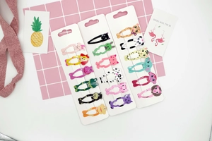 Close-up of cute cartoon animal hair clip sets including panda and cat designs for girls
