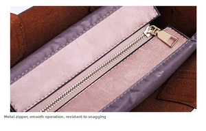 Macro detail of smooth metal zipper and premium pink leather edge with suede lining