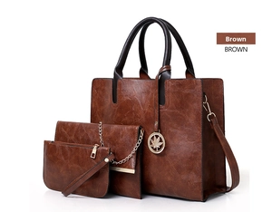 Close-up of three-piece brown PU leather bag set with lychee texture and leaf charm