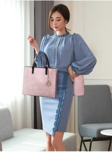 Detail of pink lychee textured tote bag with dark brown handles on elegant blue lace dress