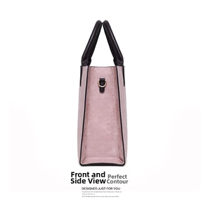 Detailed side view of pink PU leather handbag featuring black handles and gold hardware