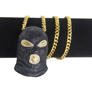 Detail of hip hop iced-out balaclava pendant on thick gold chain display