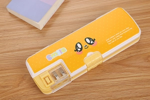 Detail of yellow kids pencil case featuring a built-in sharpener and cute smiley design