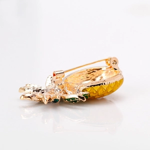 Creative gold pineapple brooch pin with detailed metal backing on a white background
