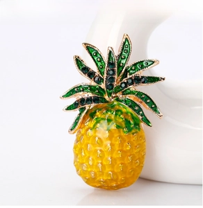Macro detail of pineapple brooch with yellow enamel and sparkling green rhinestones