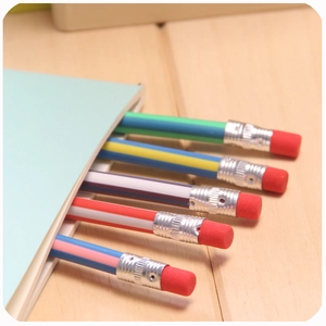 Set of flexible striped pencils with red erasers tucked into a blue notebook spine
