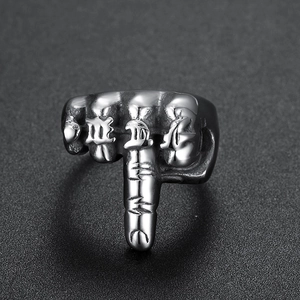 Detailed view of vintage stainless steel fist ring with relief lettering and silver finish