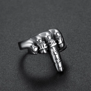 Macro detail of retro stainless steel fist ring with engraved Gothic lettering