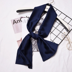 Navy blue silk-like skinny scarf for women styled on a fashion magazine backdrop