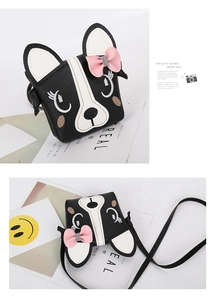 Detail of dog-shaped kids crossbody bag in black leather with pink bow and embroidery