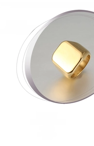 Detailed close-up of a wide polished gold titanium steel ring for men with a metallic finish