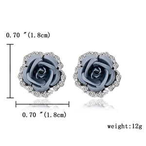 Detailed close-up of grey rose earrings with white rhinestones and size measurements