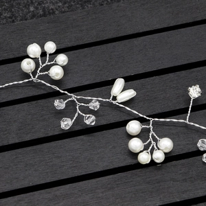 Close-up of handmade bridal headband with pearls and crystals on silver wire