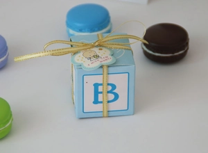 Close-up of light blue baby shower candy box with gold ribbon and I LOVE YOU BABY tag