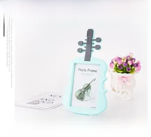 Detailed close-up of mint green violin-shaped photo frame with 135x172mm display area