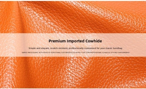Macro shot of high-quality orange cowhide leather with a distinct lychee grain texture