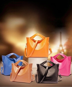 Litchi pattern leather tote bags in vibrant colors with gold metal hardware and straps