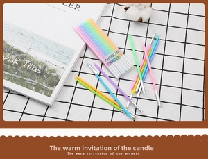 Detailed view of colorful rainbow birthday candles in transparent box with silver holders