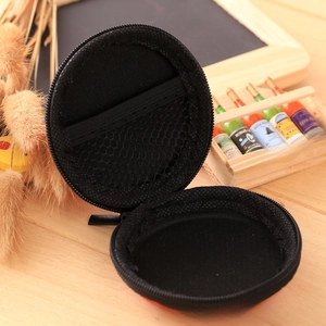 Internal mesh pocket detail of a round EVA storage case for coins and earphones
