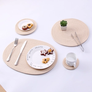 Detailed set of hand-woven beige cotton rope table mats and coasters in various sizes