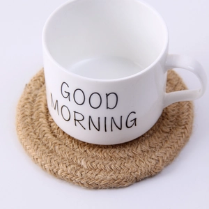 Top view of a white ceramic mug on a handmade woven hemp rope heat-resistant coaster