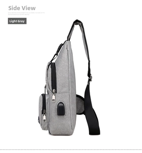 Side view of grey nylon chest bag with multiple zip compartments and external USB port