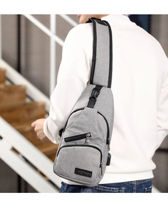 Detail of the ergonomic shoulder strap and back view of the grey oxford crossbody bag