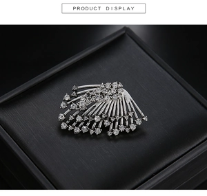 Detail view of vintage silver fan-shaped earring with brilliant inlaid rhinestones