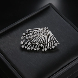 Elegant fan-shaped silver alloy brooch with clear rhinestones on a black jewelry box