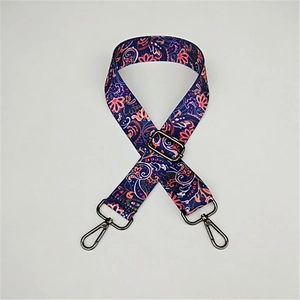 Detail of adjustable paisley strap with dark blue floral print and gunmetal hardware