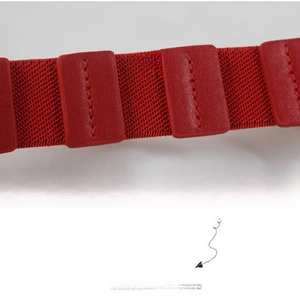 Macro detail of red high-elasticity woven waist belt with stitched leather patches