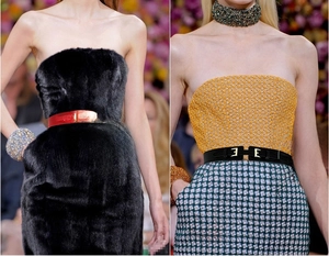 Detail of red and black skinny elastic belts with gold H-shaped metal buckles on skirts