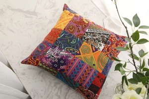 Detail of bohemian cotton linen pillowcase with colorful patchwork patterns and tassels