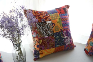 Detail of bohemian cotton linen pillow cover with tassels and colorful patchwork pattern