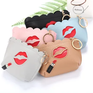 Detail of scalloped PU leather coin purses with red lip patch and lipstick charm