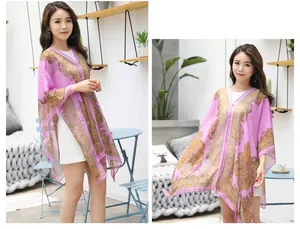Close-up of purple chiffon shawl featuring intricate golden paisley print and pearl accents