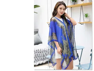 Detail of blue chiffon sun protection shawl featuring vintage paisley patterns and soft texture