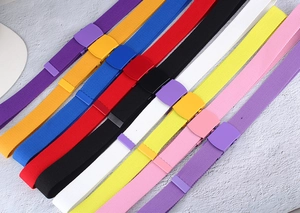 Diagonal layout showing colorful nylon canvas belts with matching matte spray paint buckles