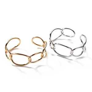 Detail of interlocking oval link geometric open bracelets in polished gold and silver