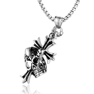 Detail of gothic cross pendant with skull design in vintage silver stainless steel