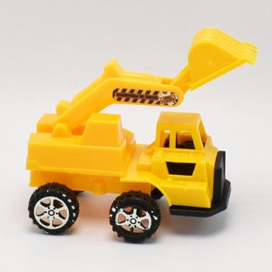 Detail of yellow toy excavator with movable arm and safety warning stickers
