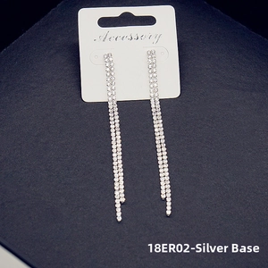 Detailed view of silver-tone tassel earrings with double-row sparkling rhinestones