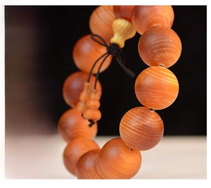 Detailed macro view of natural blood dragon wood beads with fine grain and gourd pendant