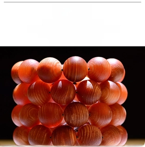 Macro detail of polished reddish-brown wooden beads with distinct annual ring textures