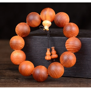 Detailed macro view of blood dragon wood beads with natural texture and gourd pendant