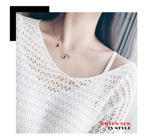 Detail of rose gold Evil Eye necklace featuring blue main stone and crystal pave on neck