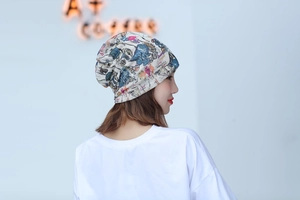 Detail of soft fabric turban hat with character print and fashion lettering for women