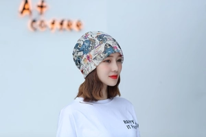 Detail shot of a lightweight floral turban hat worn by a model in casual setting