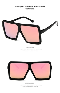 Close-up of oversize square sunglasses with black frames and pink silver gradient lenses