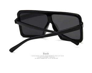 Detail view of the folded back frame and temples of black oversized square sunglasses
